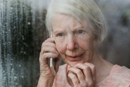 Elder Caucasianwoman Looking Out of Storm Window
