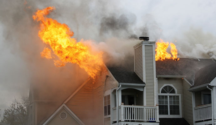 Worker restoring fire damaged house