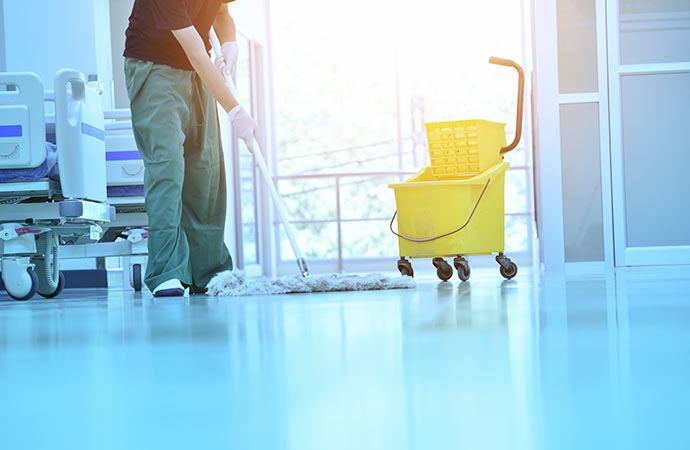 worker cleaning hospital