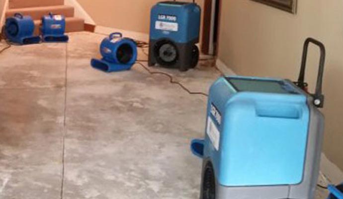 water damage restoration service by water removal equipment